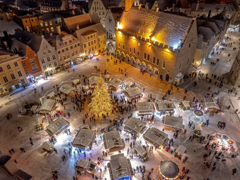An aerial view of illuminated Tallinn cityscape with Christmas Market in the center in Estonia