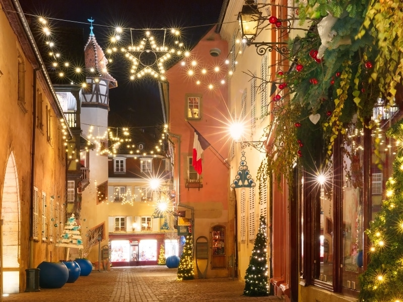 Traditional Alsatian half-timbered houses in old town of Colmar, decorated and illuminated at christmas time, Alsace, France