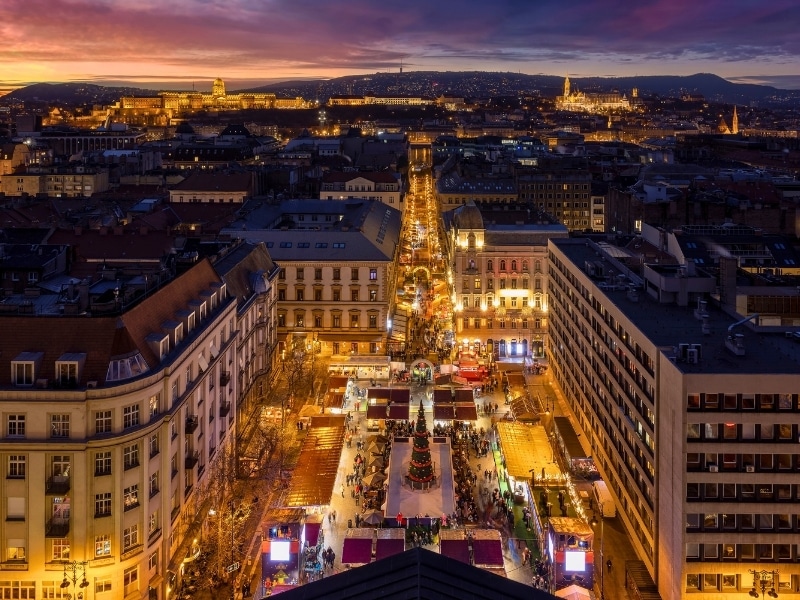 Elevated, panoramic view over the illuminated skyline of Budapest, Hungary, with the Castle and Fishermen's Bastion in the background