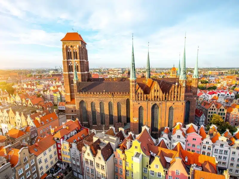 Cityscape aerial view of a colorful old town with and cathedral at sunset