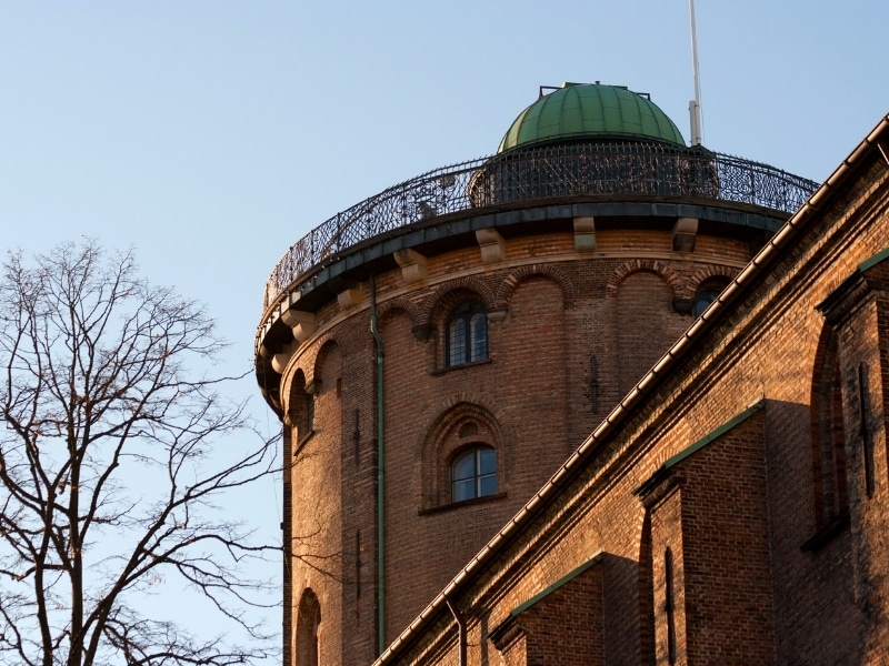 The top of the Round Tower (Rundetärn in Danish) illuminated by the setting winter sun.