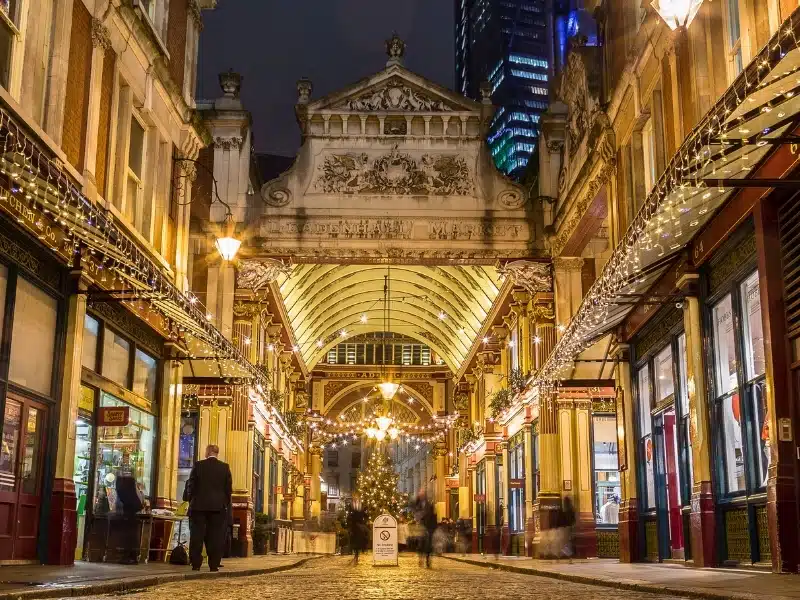 The outside of the Leadenhall Market in London at night during the Christmas Season