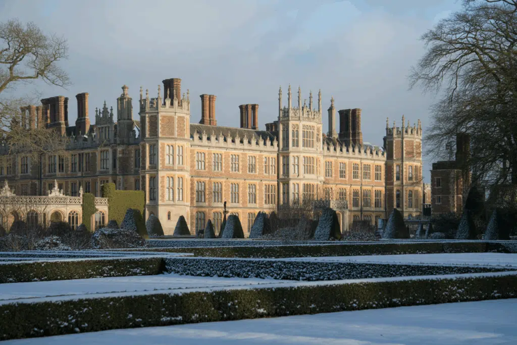 A photograph of Hampton Court Palace in a serene winter landscape. 