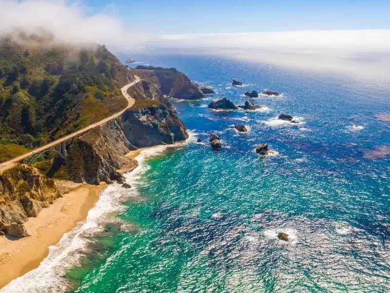 Magical aerial view of the route 101 by the Californian Pacific Coast on the way from Los Angeles to San Francisco near Big Sur Bixby Bridge.
