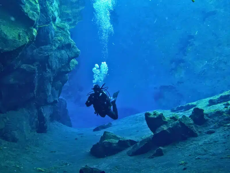 Scuba Diving at Silfra, Iceland in Dry Suits at the Continental Divide at the bingvellir National Park in Iceland.