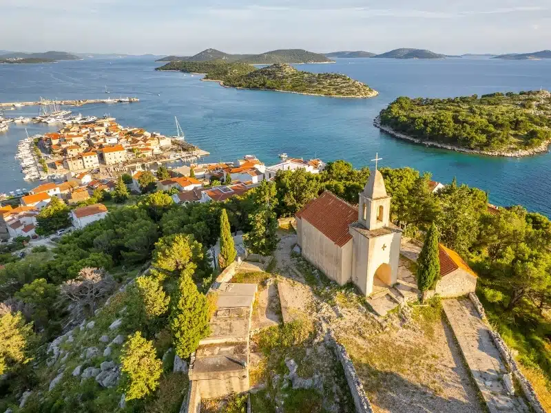 Picturesque St. Nicholas church and the old town of Tribunj on a small island in Adriatic sea, Dalmatia region of Croatia. 