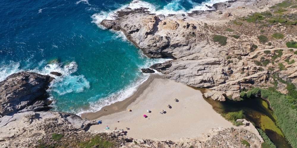 Aerial drone photo of Nas Beach with the river flowing into the Aegean Sea on Ikaria