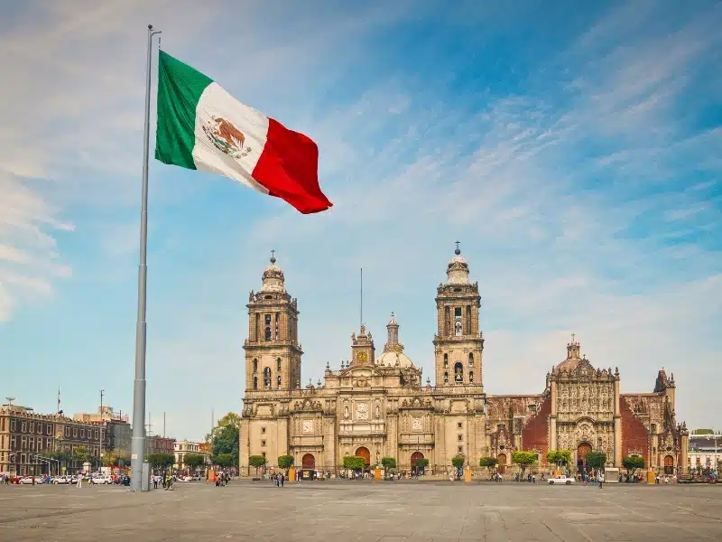 Main square Zocalo with cathedral and big Mexican flag