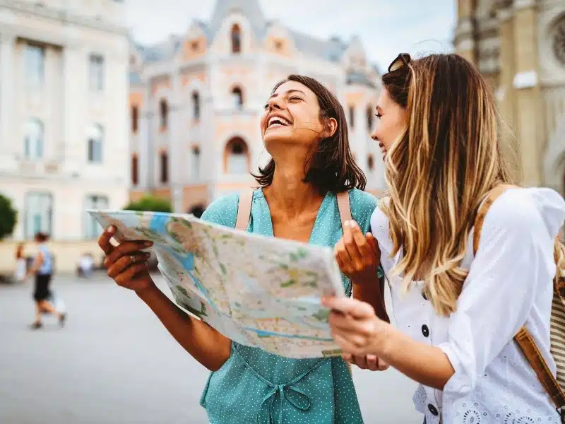 Traveller looking for direction in the city for a local with a map