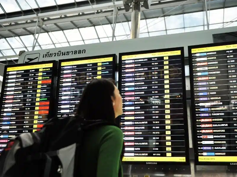 An air traveler views a flight notice board in the departures terminal of Suvarnabhumi Airport in Bangkok, Thailand. 