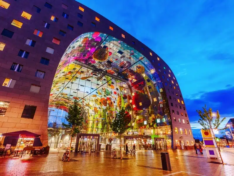 Modern market hall in Rotterdam at night designed by architect firm MVRDV. 