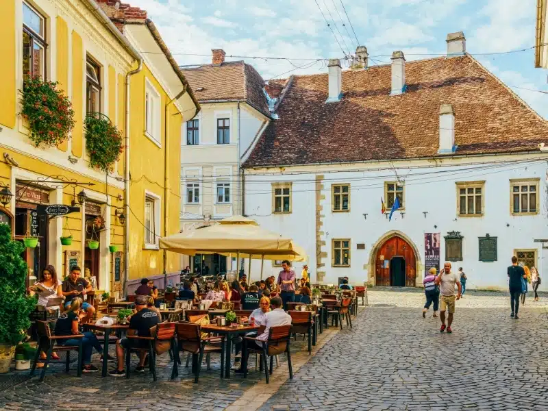 Tourists Relaxing Downtown In The Old Center Of Cluj Napoca