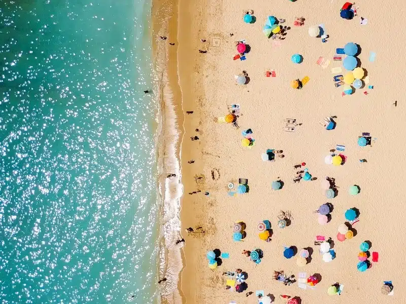 Aerial view of people under parasonls on a beach in Portugal