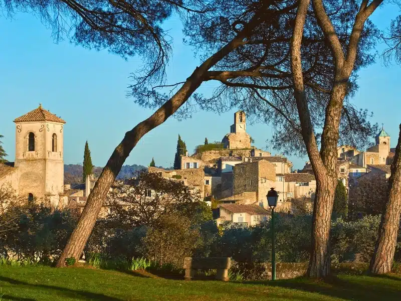 Stone village with a church and surrouned by Cypress trees