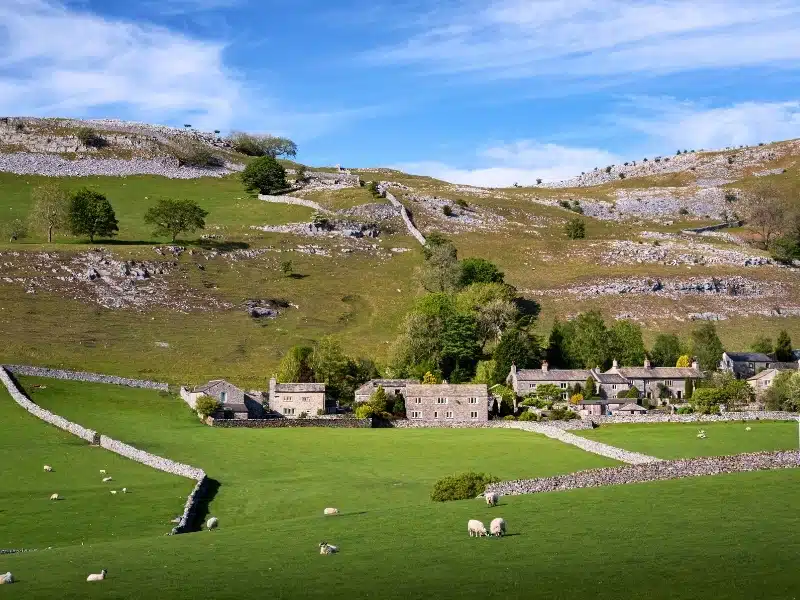 Village of Feizor in spring backed by Pot Scar, Yorkshire Dales National Park, Yorkshire, England, United Kingdom, Europe