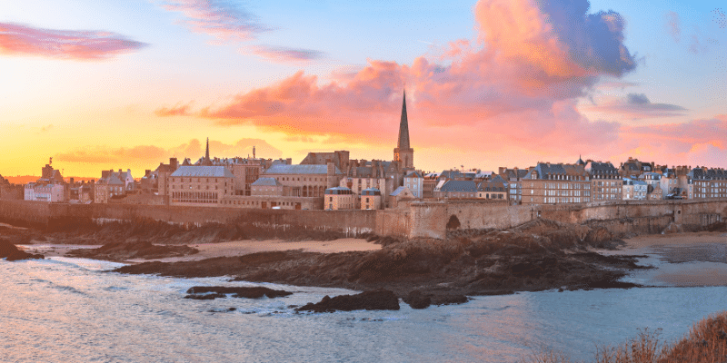 Panoramic view of walled city Saint-Malo with St Vincent Cathedral at sunrise.