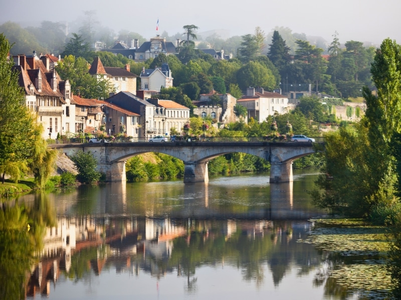 Picturesque view of a French river town and bridge