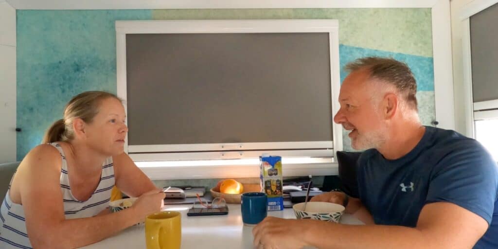 Couple talking across a table in a motorhome