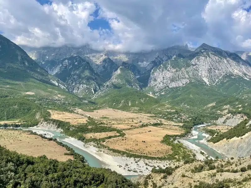 view across a wide river valley to distant mountains