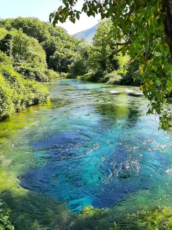 Clear green, blue and turquoise waters flowing from a natural spring
