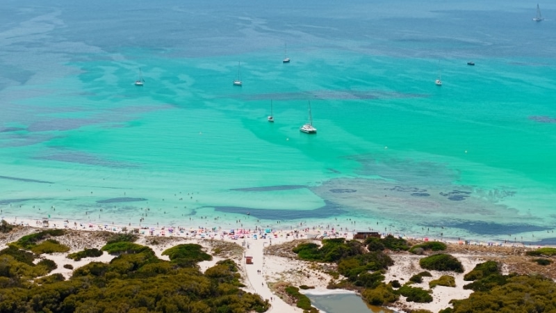 People relaxing and swimming in turquoise waters
