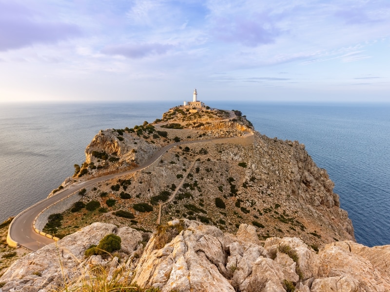 A beautiful winding road leads to the scenic lighthouse perched on a high cliff above the sea
