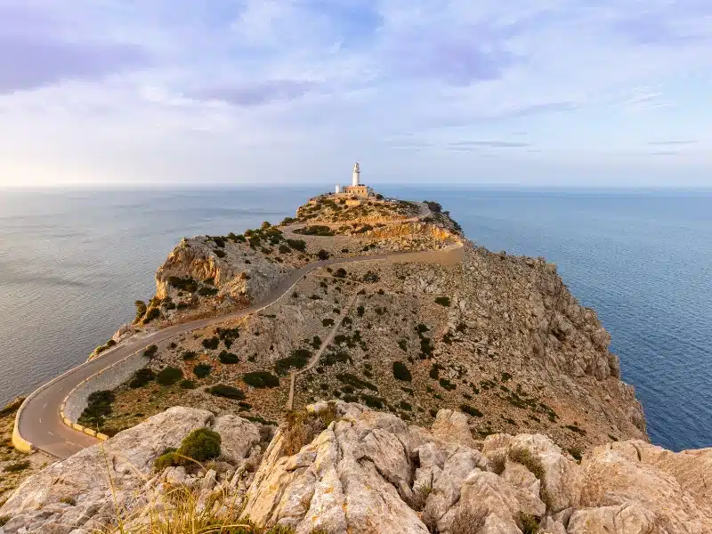 A beautiful winding road leads to the scenic lighthouse perched on a high cliff above the sea