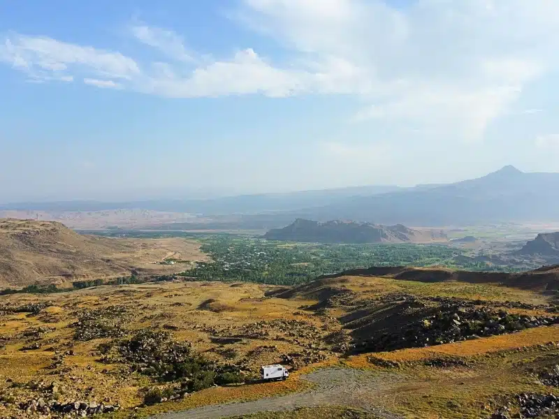 white motorhome parked on a high spot of a valley