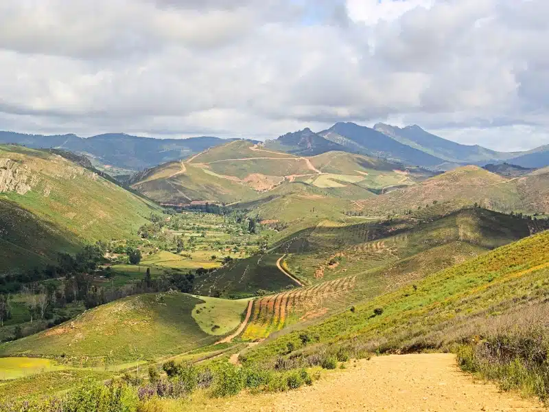 grassy covered mountain range and a cloudy sky