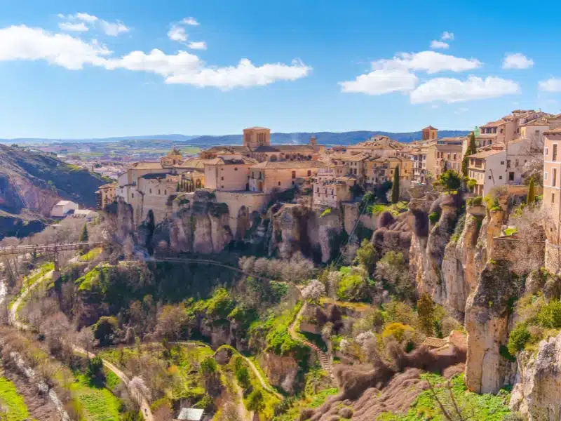 Cuenca with hanging houses, cliffs, valley and bridge in spring