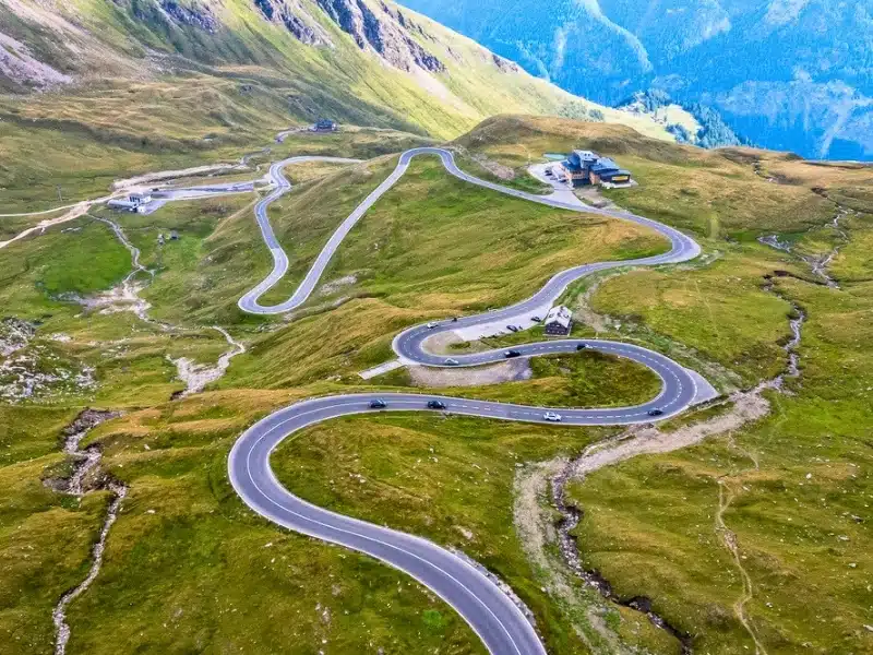 Beautiful view of the famous Austrian seršentine road Grossglockner Hochalpenstrasse. Aerial view of scenic Grossglockner High Alpine Road route in Austria with mountains and clouds in summer