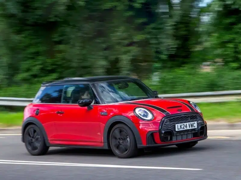 2024 red Mini Cooper S car driving on a British country road