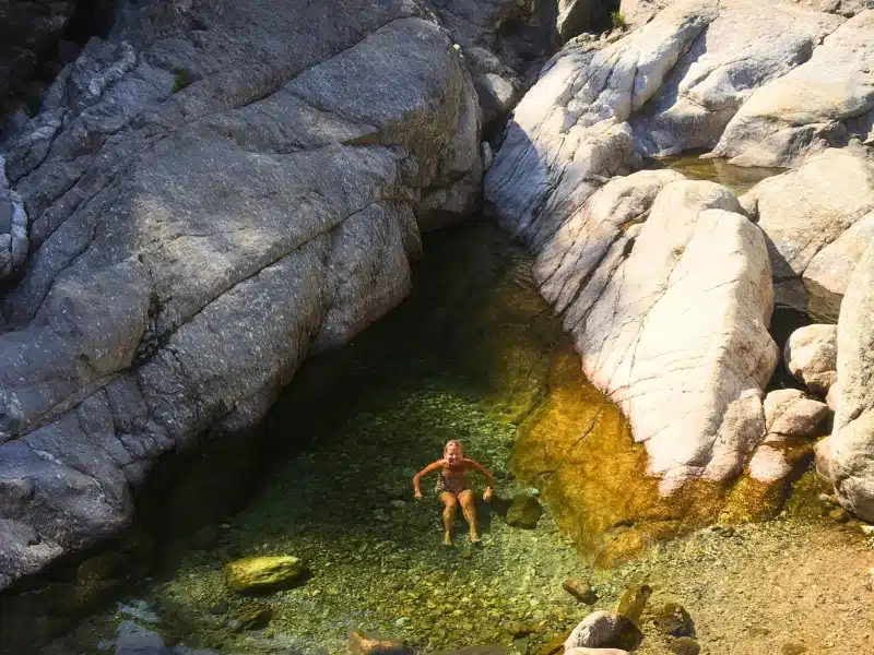 woman bathing in a natural pool in a gorge
