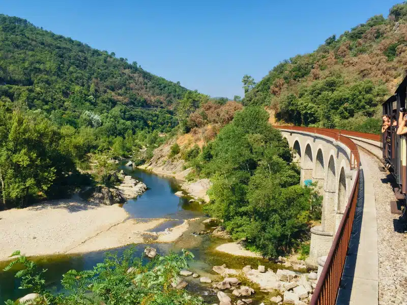 Steam train passing over a viaduct near Generargues in the Cevennes