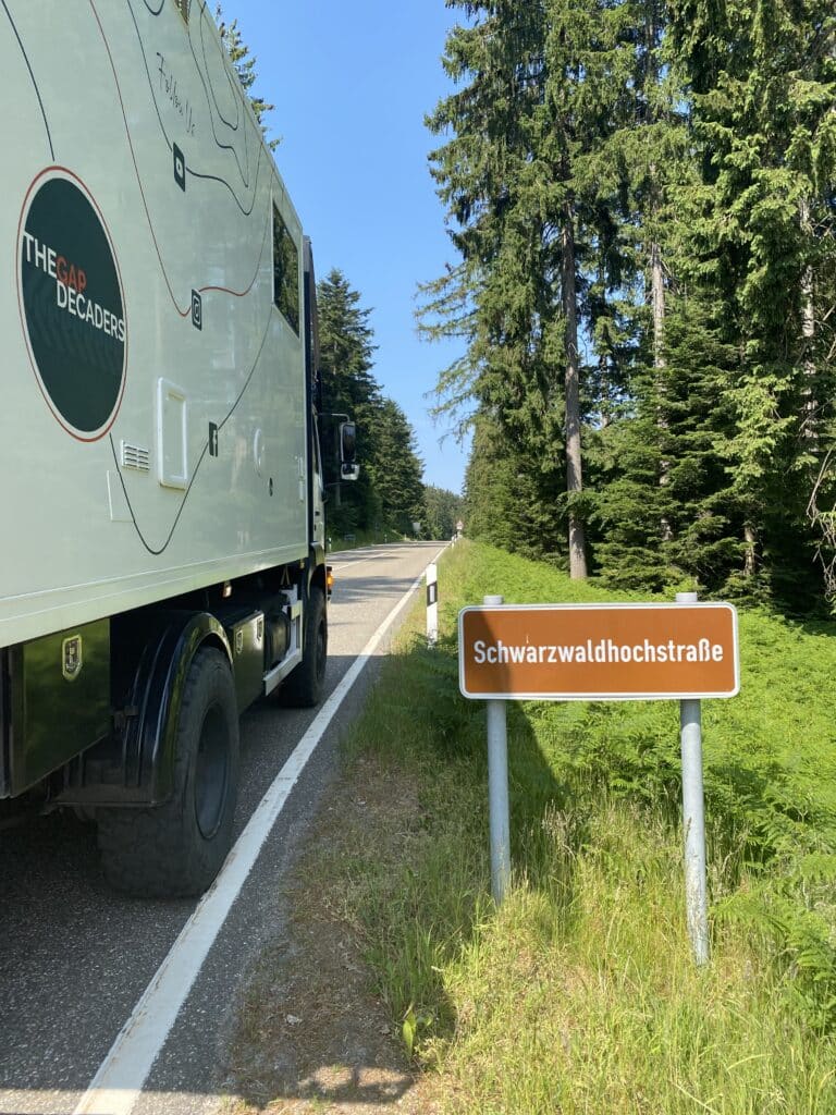 white camper truck at the start of the Black Forest High Road with a sign