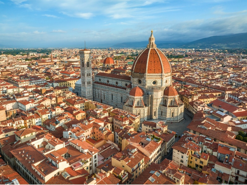 Aerial view of Florence city skyline showcasing the iconic Duomo Cathedral of Santa Maria del Fiore surrounded by the historic city center