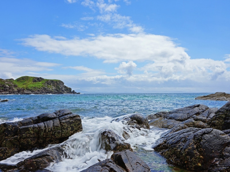 Looking across the beautiful turquoise sea towards the Isles of Eigg and Rum from the Point of Sleat, the southern most point of Skye