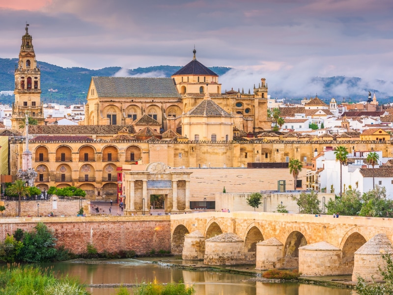 Cordoba, Spain at the Roman Bridge and Mosque-Cathedral on the Guadalquivir River.