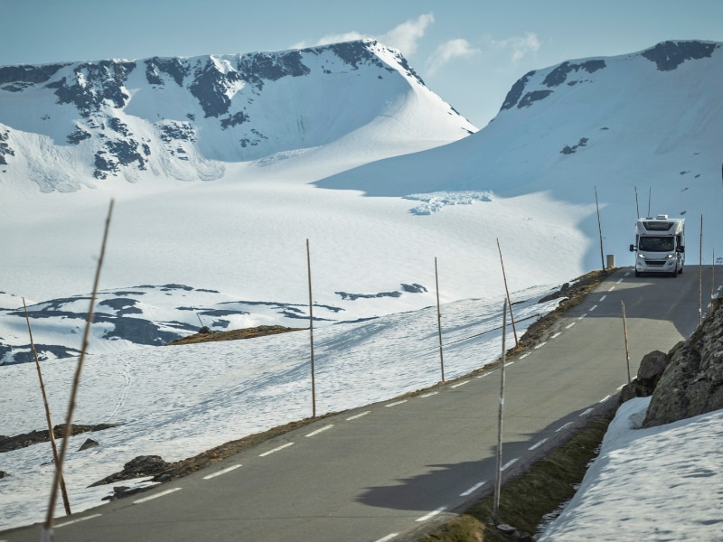 Motorhome on a Scenic Norwegian Mountain Route surrounded by snow